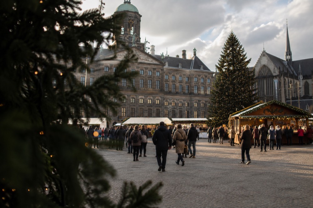 A quiet corner of Dam Square with trees overhanging the water