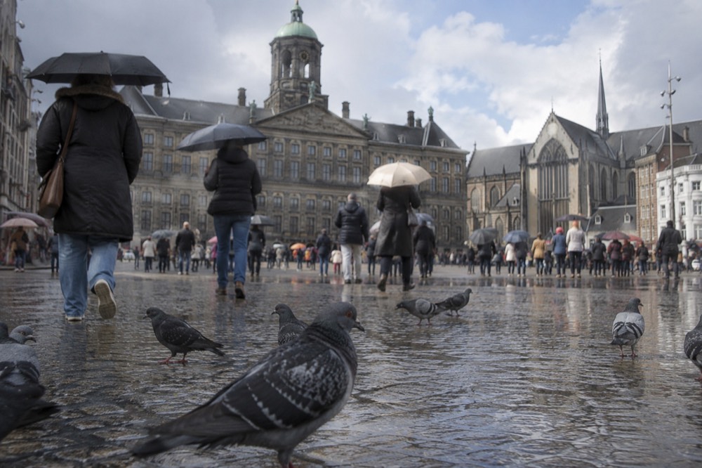 A street-level view of Dam Square on an ordinary weekday morning