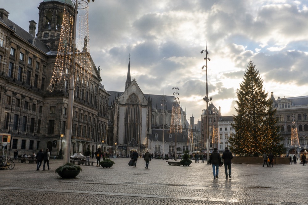 The waterfront near Dam Square under a broad grey northern sky