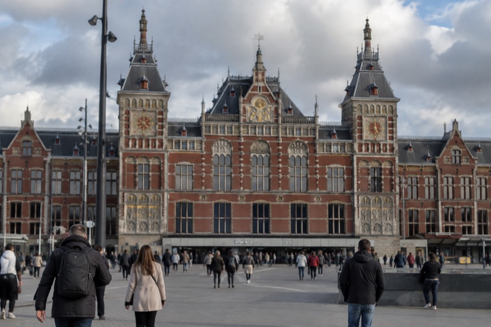 The neo-Gothic facade of Amsterdam Centraal station seen from the station forecourt