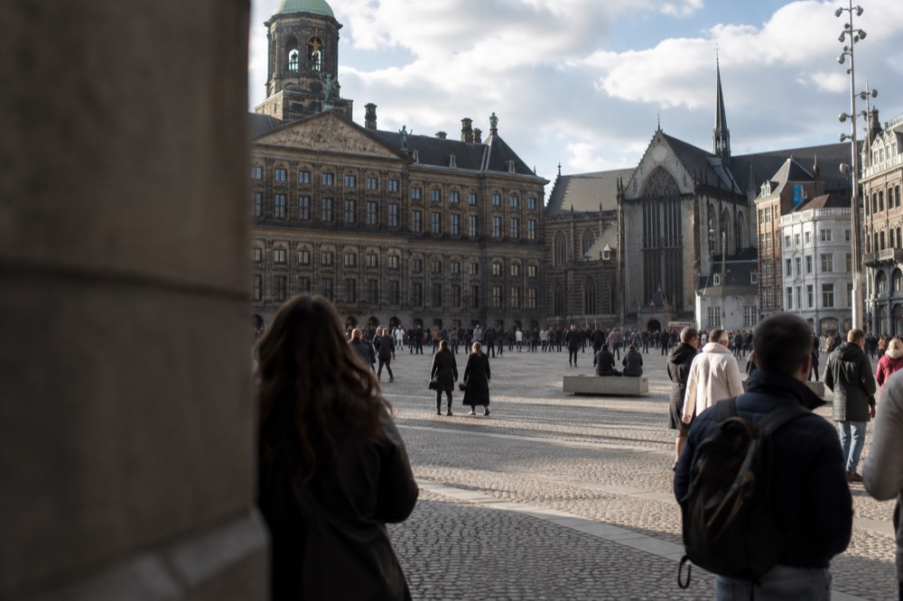 The waterfront near Dam Square under a broad grey northern sky