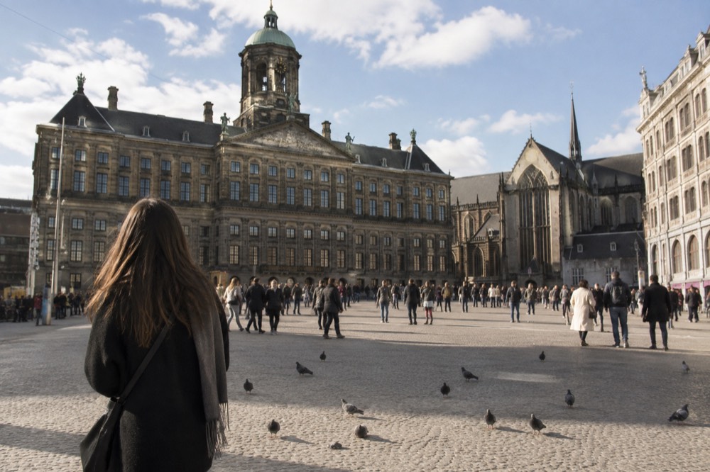 Brick facades and a quiet canal edge beside Dam Square