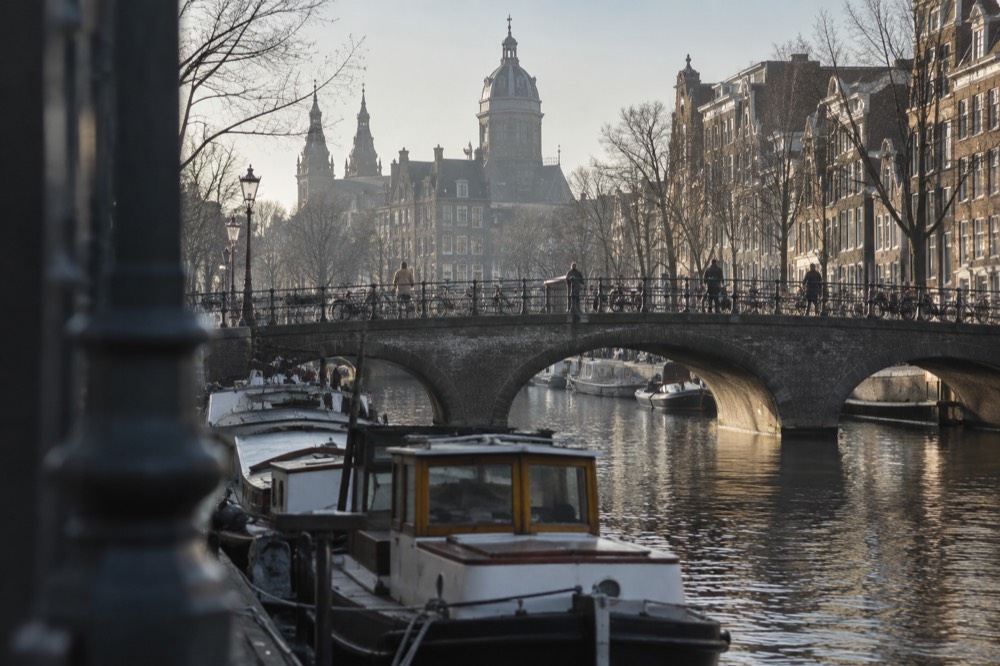 A canal bridge and moored boats close to Dam Square
