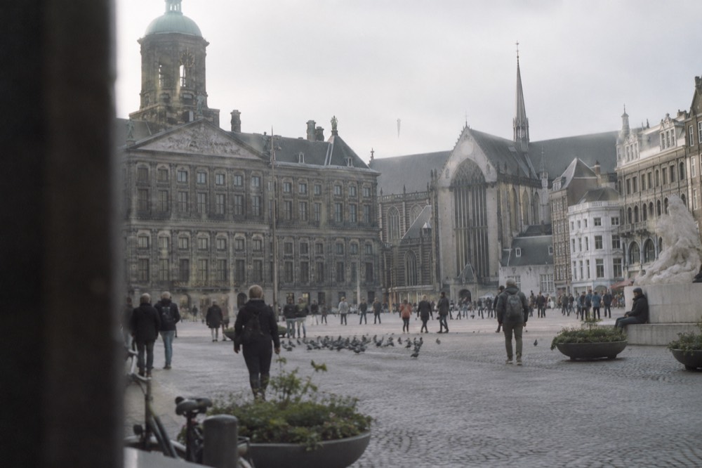 A street-level view of Dam Square on an ordinary weekday morning