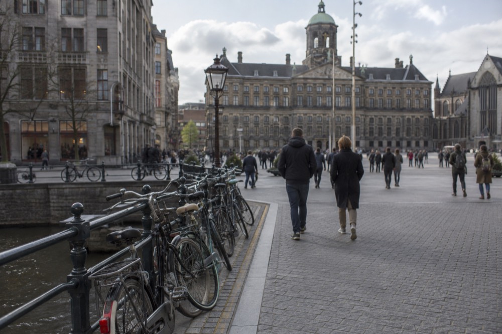 The approach to Dam Square, with bicycles leaning against the railings