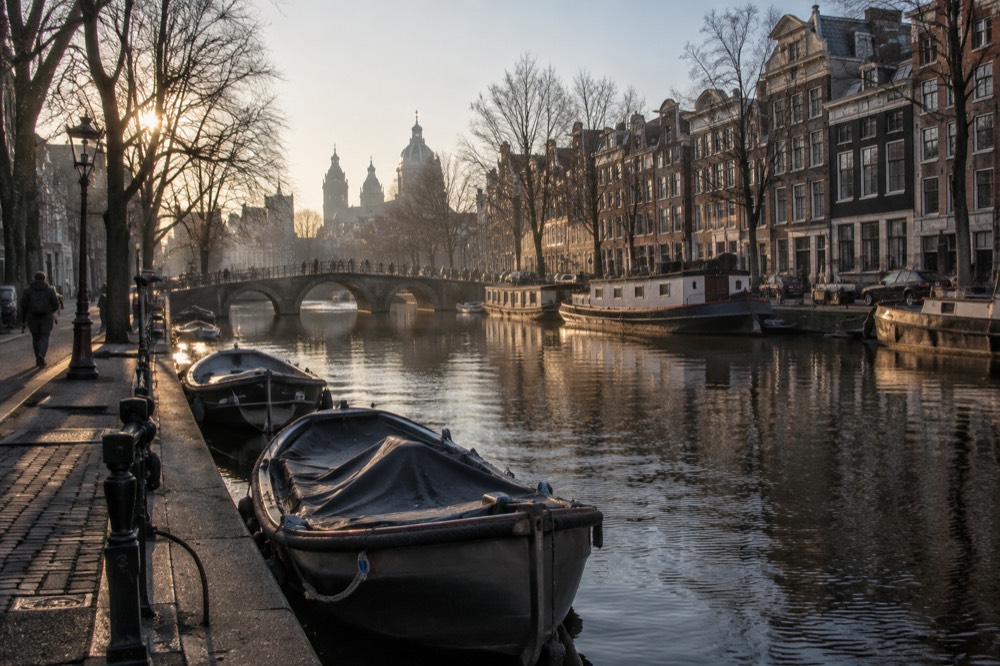 A canal bridge and moored boats close to Dam Square