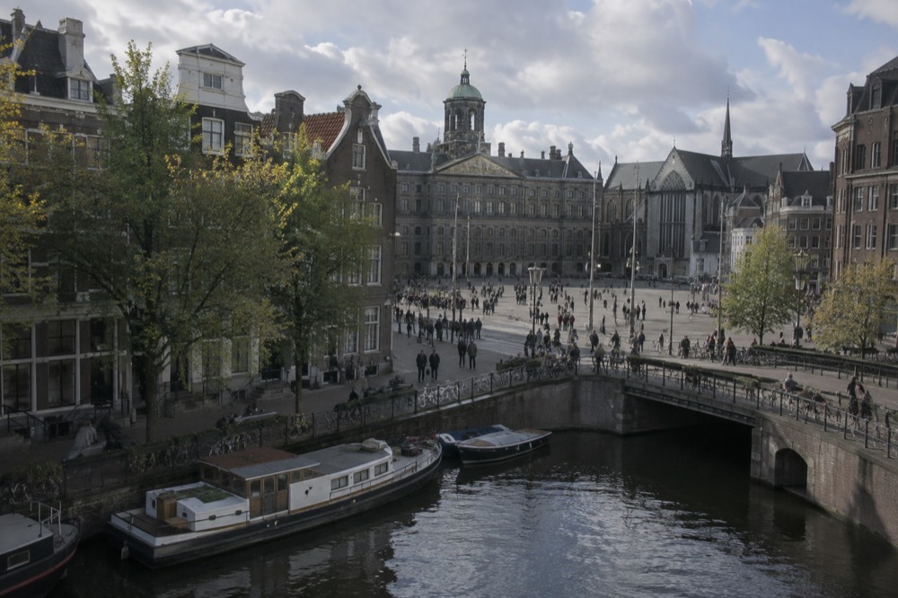 A canal bridge and moored boats close to Dam Square