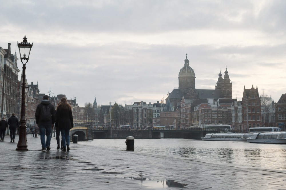 The waterfront near Dam Square under a broad grey northern sky