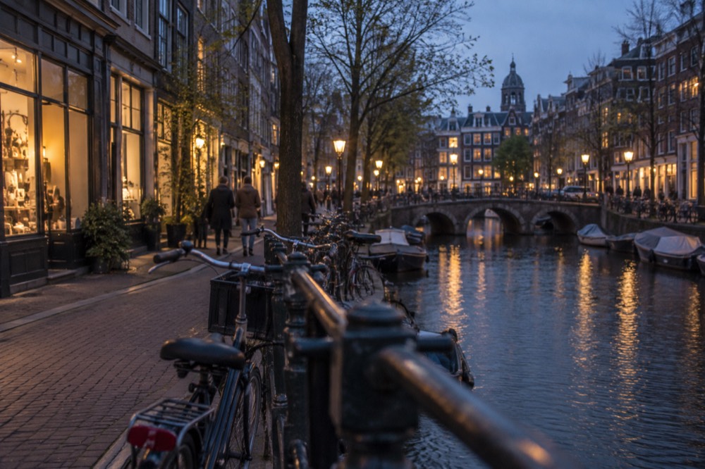 Shop windows and bicycles along a canal in the Nine Streets area
