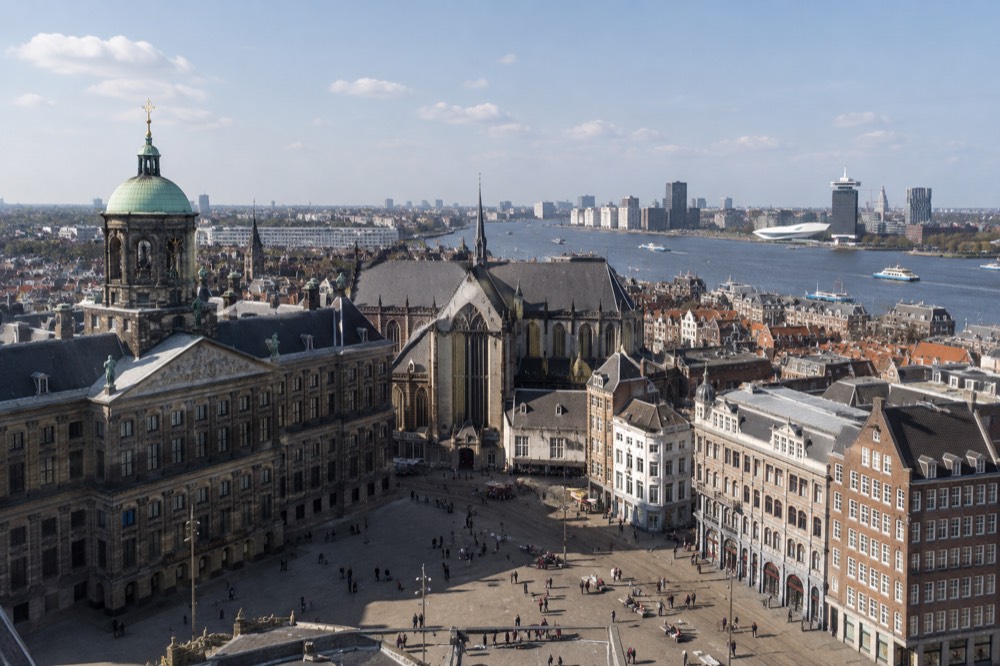 View from a high observation deck over Amsterdam rooftops and the IJ river
