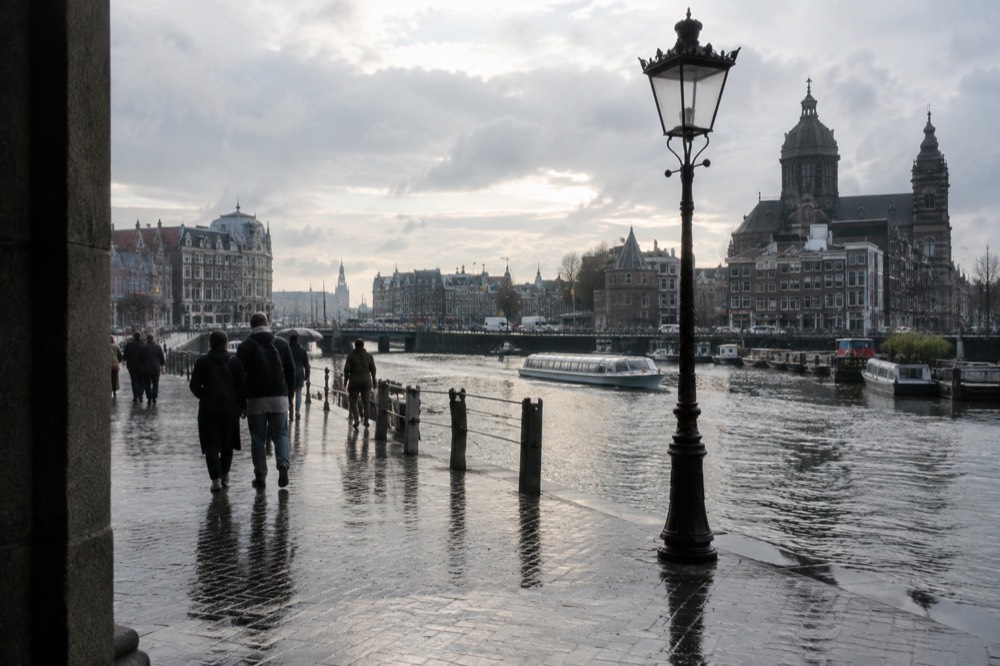 The waterfront near Dam Square under a broad grey northern sky