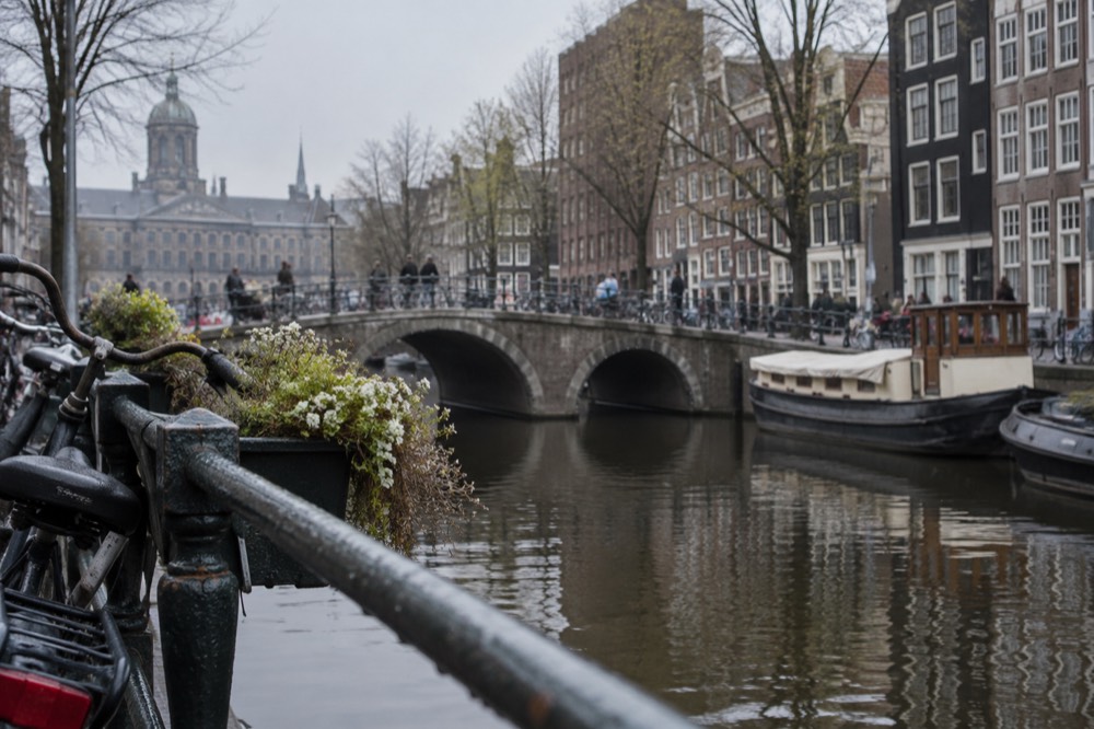 A canal bridge and moored boats close to Dam Square