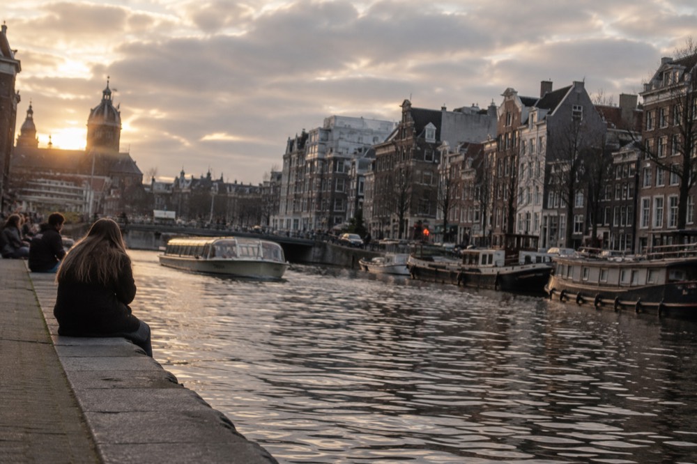 The waterfront near Dam Square under a broad grey northern sky