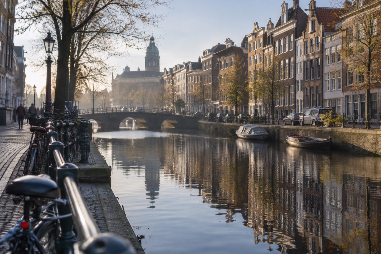 Canal houses reflected in the water of an Amsterdam gracht