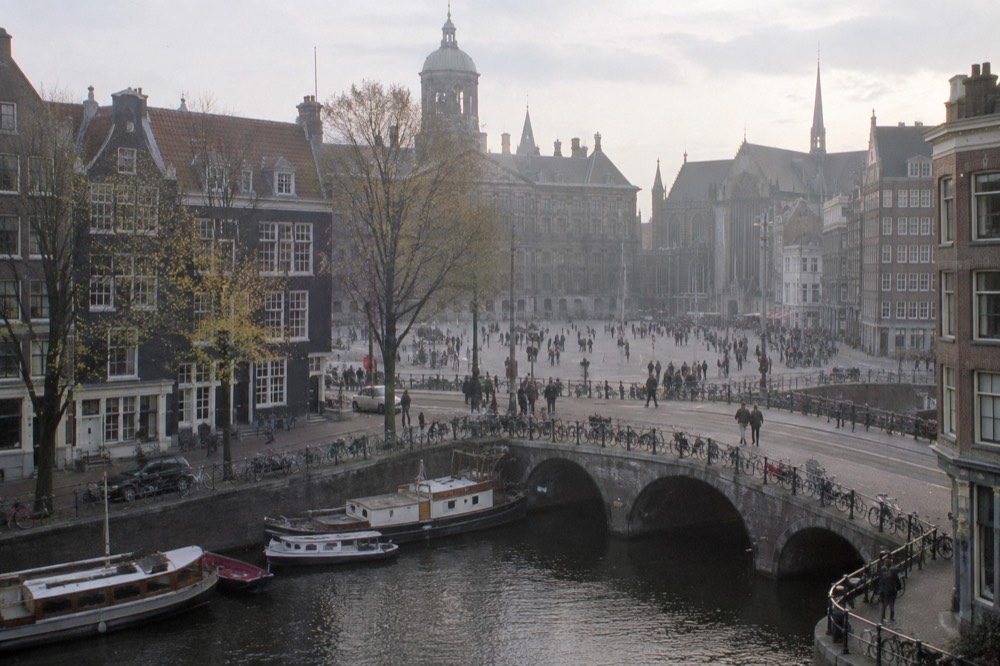 A canal bridge and moored boats close to Dam Square