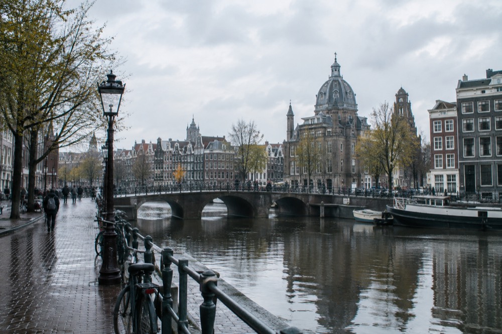 A canal bridge and moored boats close to Dam Square