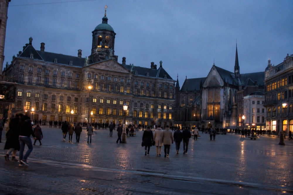 People walking past Dam Square, seen from across the street