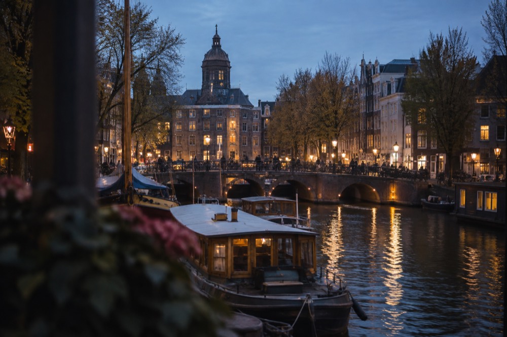 A canal bridge and moored boats close to Dam Square