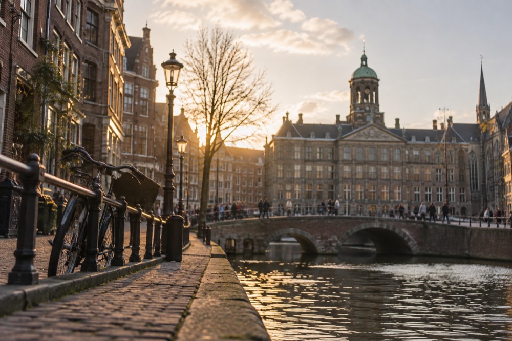 Brick facades and a quiet canal edge beside Dam Square