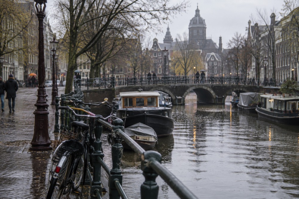 A canal bridge and moored boats close to Dam Square