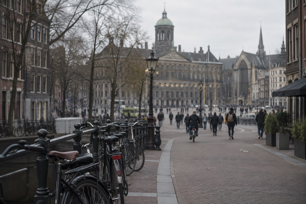 The approach to Dam Square, with bicycles leaning against the railings