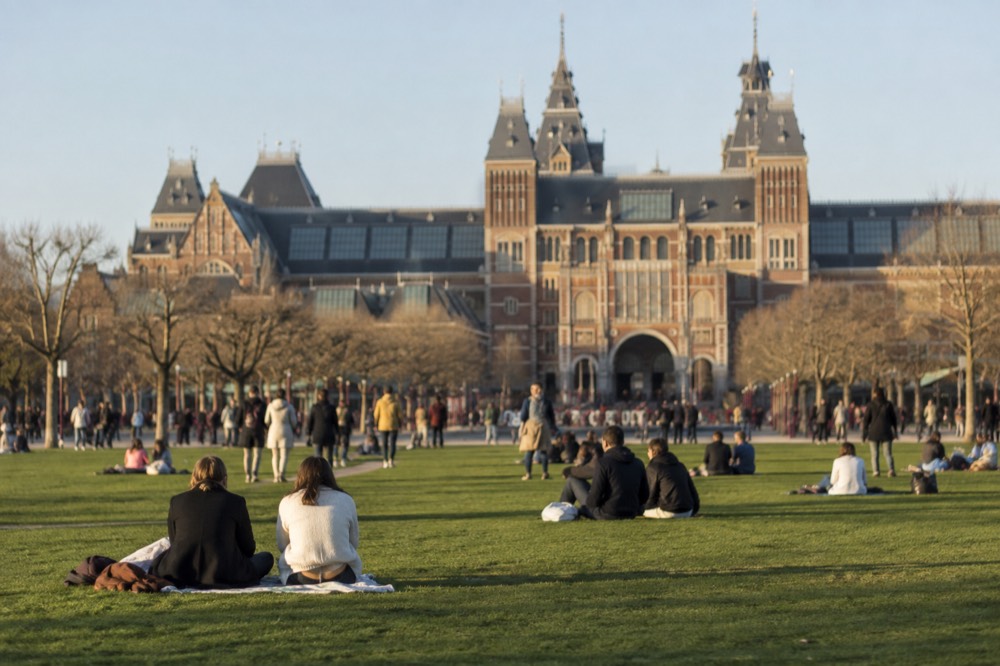 Museumplein lawn in front of the Rijksmuseum building on a bright afternoon