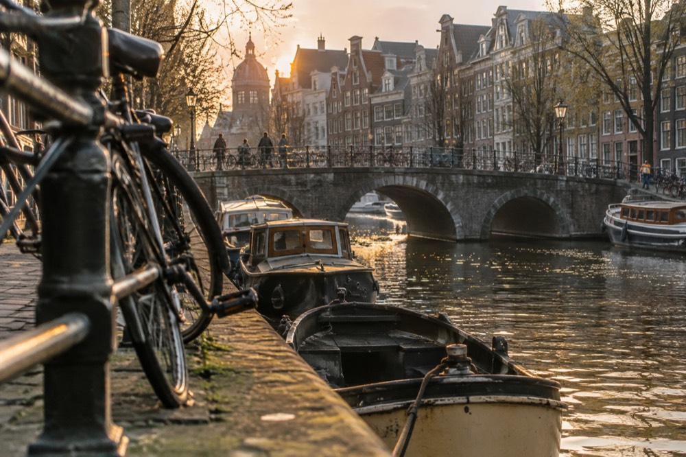 A canal bridge and moored boats close to Dam Square