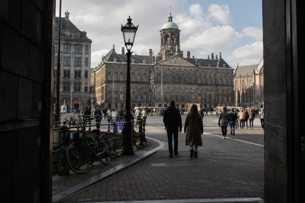 The approach to Dam Square, with bicycles leaning against the railings