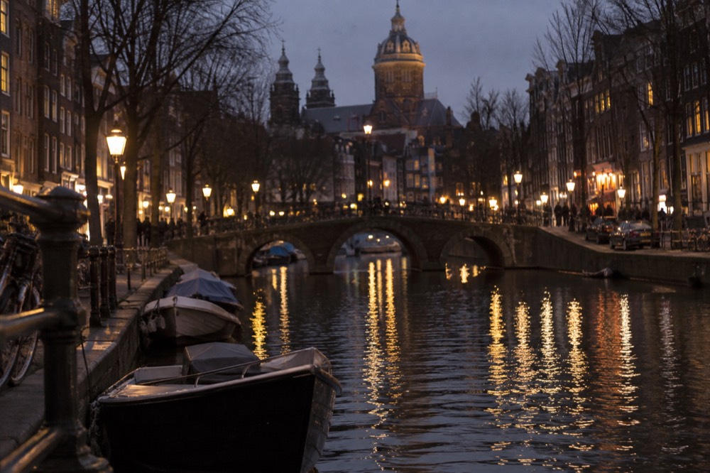 A canal bridge and moored boats close to Dam Square