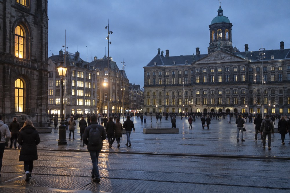 People walking past Dam Square, seen from across the street