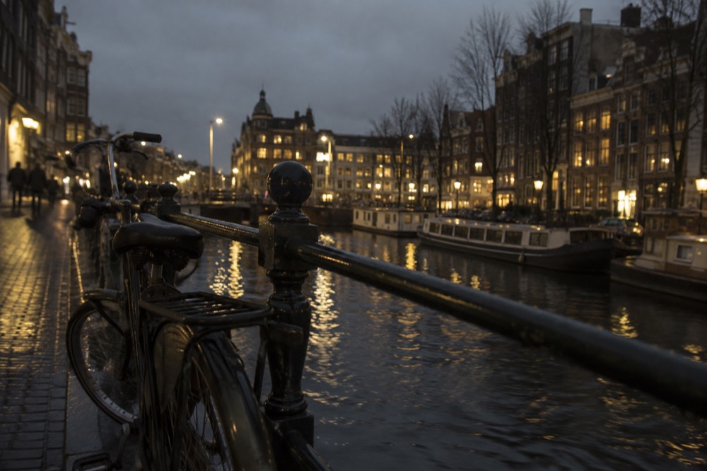 The waterfront near Dam Square under a broad grey northern sky