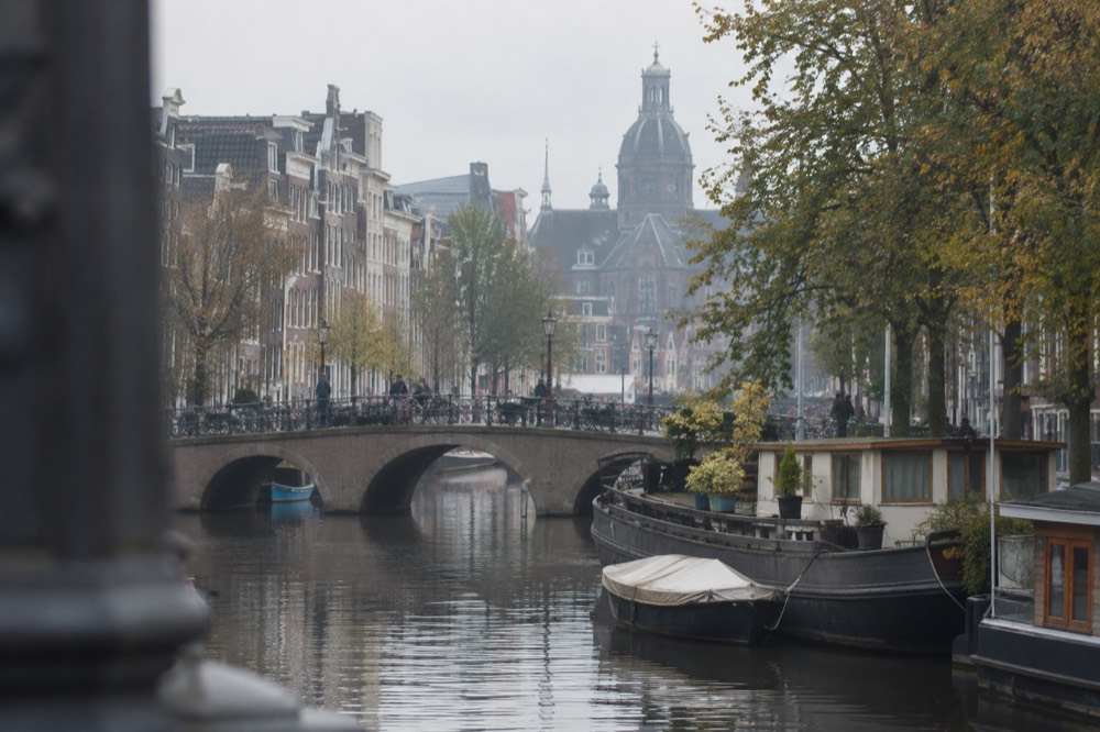 A canal bridge and moored boats close to Dam Square