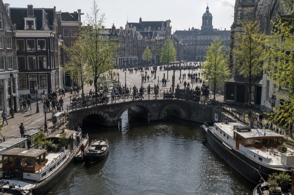 A canal bridge and moored boats close to Dam Square
