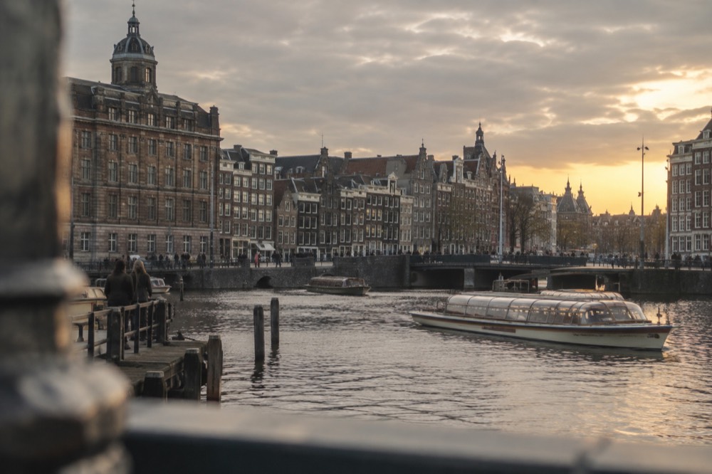 The waterfront near Dam Square under a broad grey northern sky