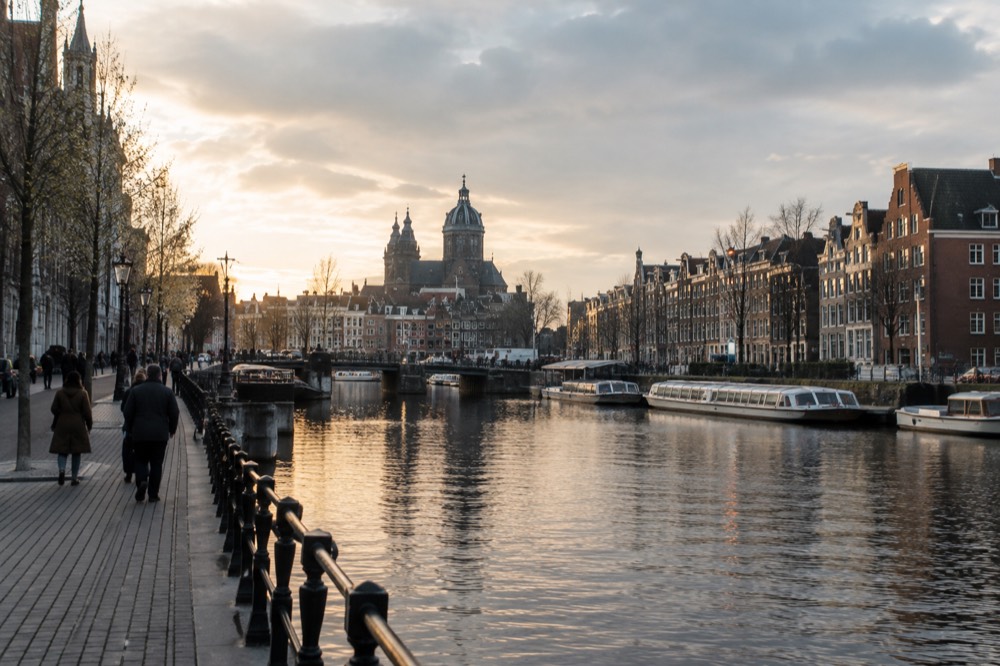 The waterfront near Dam Square under a broad grey northern sky