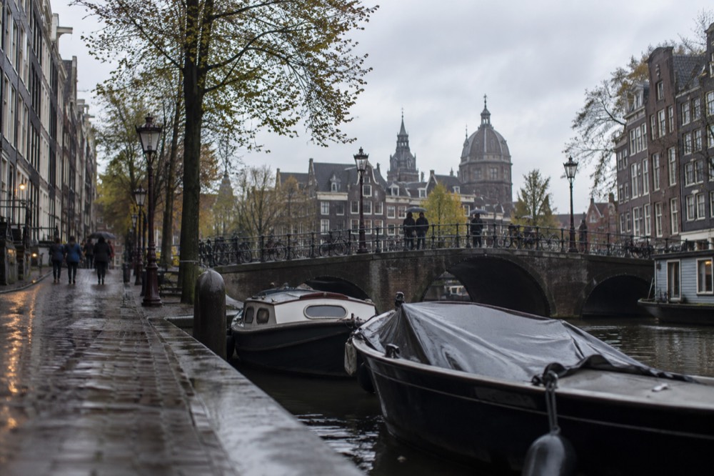 A canal bridge and moored boats close to Dam Square