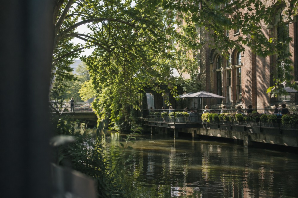 A quiet corner of Heineken Experience with trees overhanging the water