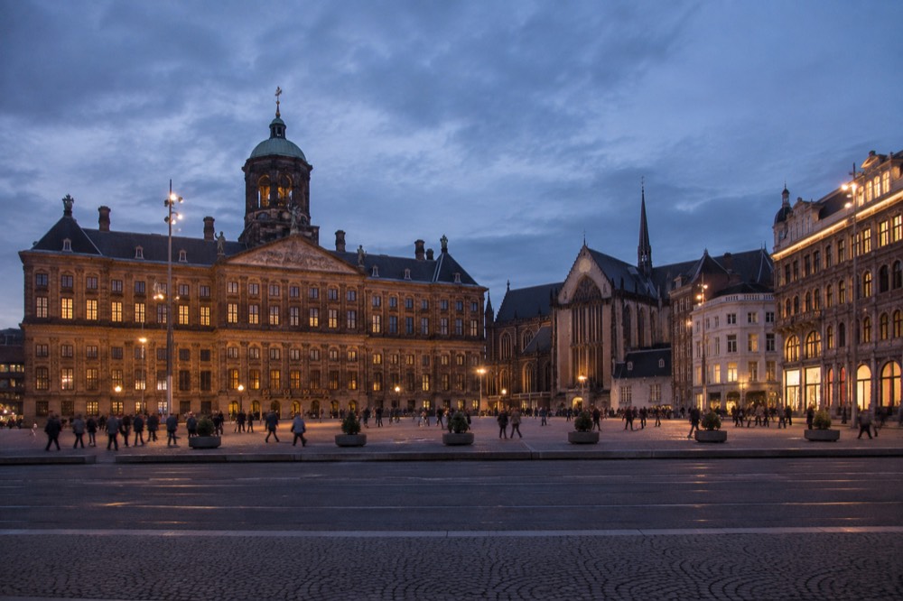 People walking past Dam Square, seen from across the street