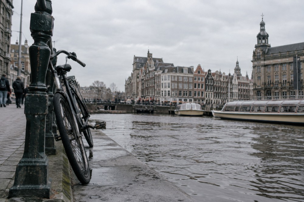 The waterfront near Dam Square under a broad grey northern sky